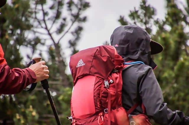 Person hiking with a close up image of their backpack