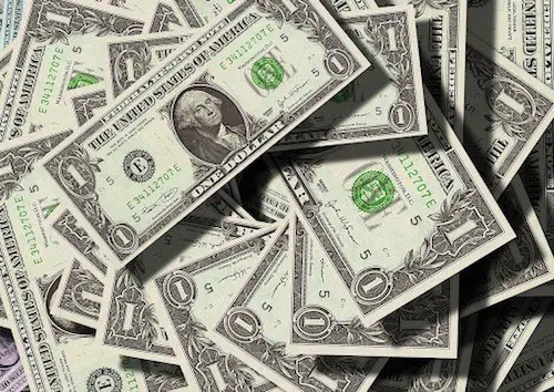 Dollar bills in a pile
