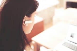 Woman answering phone on earpiece customer service