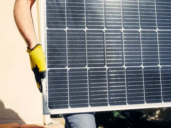 man holding solar panel